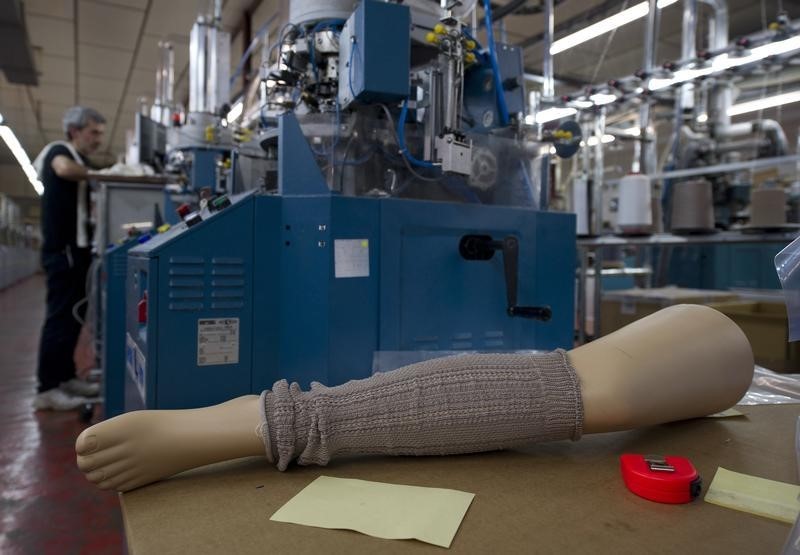 © Reuters. An employee works in a stocking factory in Calvisano near Brescia