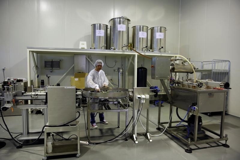 © Reuters. A worker prepares jars of thyme honey at the Stayia Farm factory in Chalkida, on the island of Evia