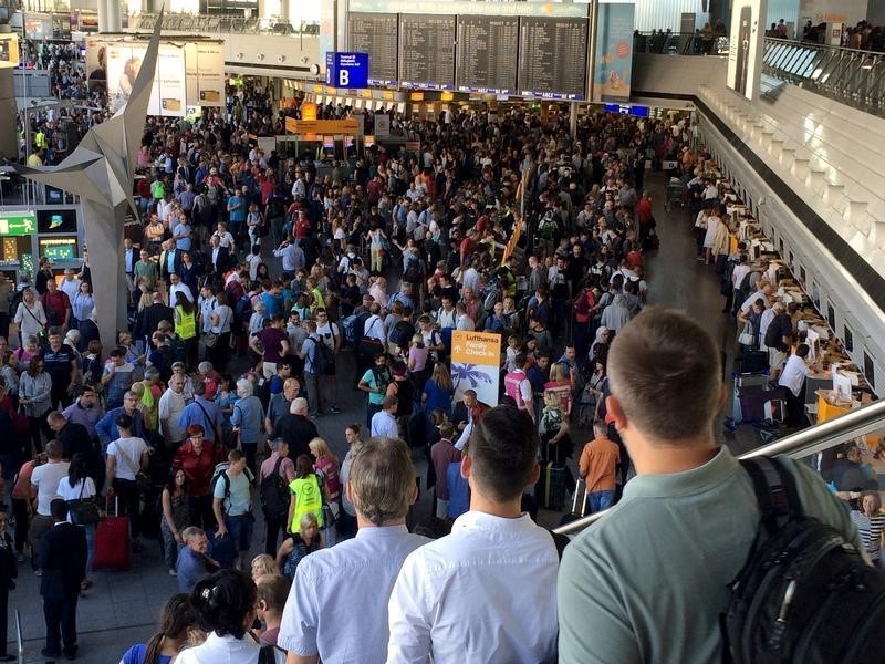 © Reuters. People gather at Frankfurt airport terminal after Terminal 1 departure hall was evacuated in Frankfurt,