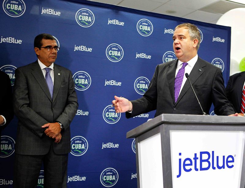 © Reuters. JetBlue CEO Robin Hayes speaks as  Cuban Ambassador to the U.S. Jose Ramon Cabanas looks on before the first commercial flight between the U.S. and Cuba in Fort Lauderdale