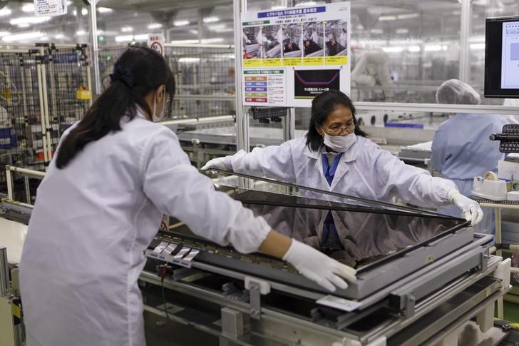 © Reuters. Women assemble an Aquos television at Sharp Corp's Tochigi plant in Yaita