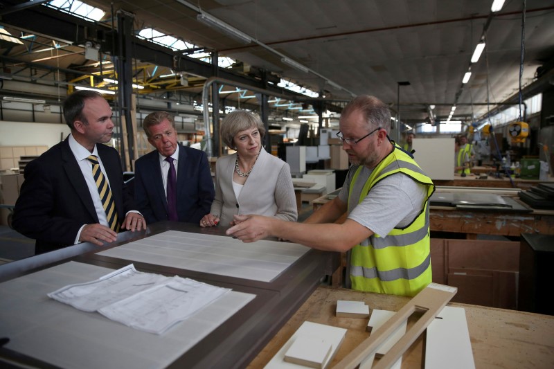 © Reuters. Britain's Prime Minister Theresa May visit a joinery factory in London