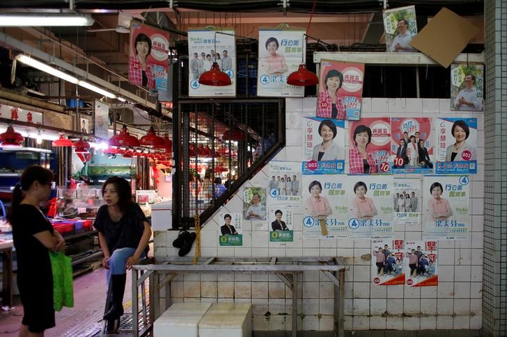 © Reuters. Candidates' campaign posters for the Legislative Council election are displayed at a market in Hong Kong, China