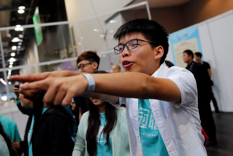 © Reuters. Student leader Joshua Wong celebrates after candidate Nathan Law won a seat in the Legislative Council election in Hong Kong, China