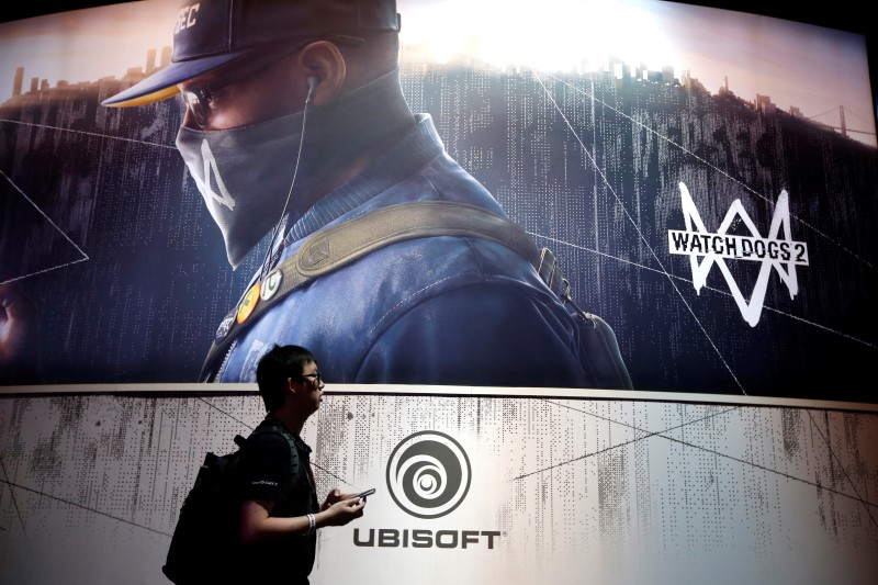 © Reuters. A man walks past the Ubisoft booth at the E3 Electronic Expo in Los Angeles