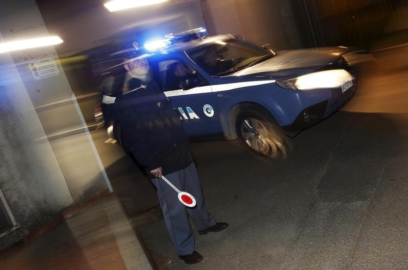 © Reuters. Italian police car leaves a police station for Operation Columbus in Pianopoli village