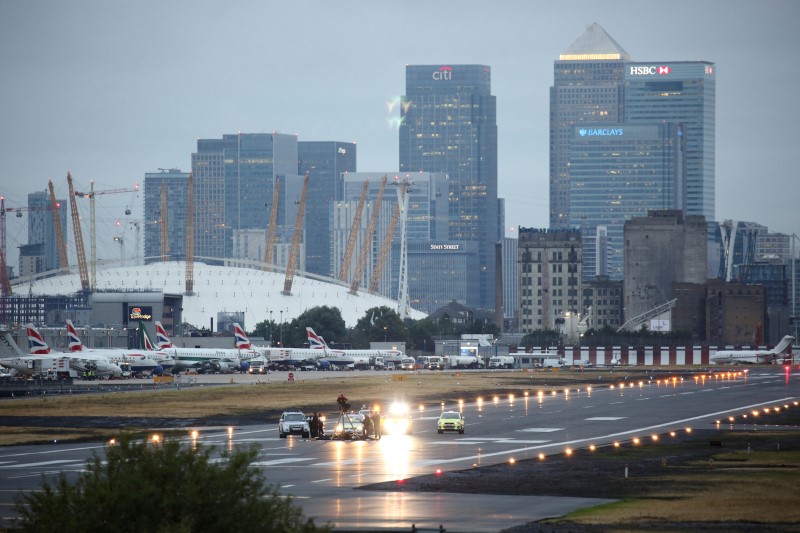 © Reuters. Police attend the scene of a "Black Lives Matter" protest on the runway at London City Airport