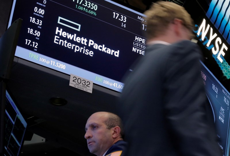 © Reuters. A trader passes by the post where Hewlett Packard Enterprise Co., is traded on the floor of the New York Stock Exchange