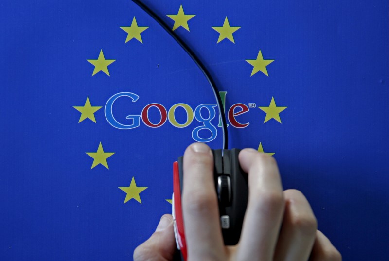 © Reuters. A woman hovers a mouse over the Google and European Union logos