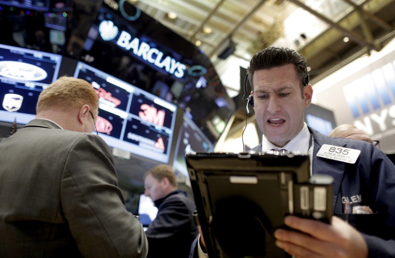 © Reuters. Traders work on the floor of the New York Stock Exchange (NYSE) shortly after the opening bell of trading session in New York