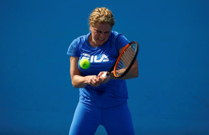 © Reuters. Belgium's Kim Clijsters hits a shot during a practice session at Melbourne Park, Australia