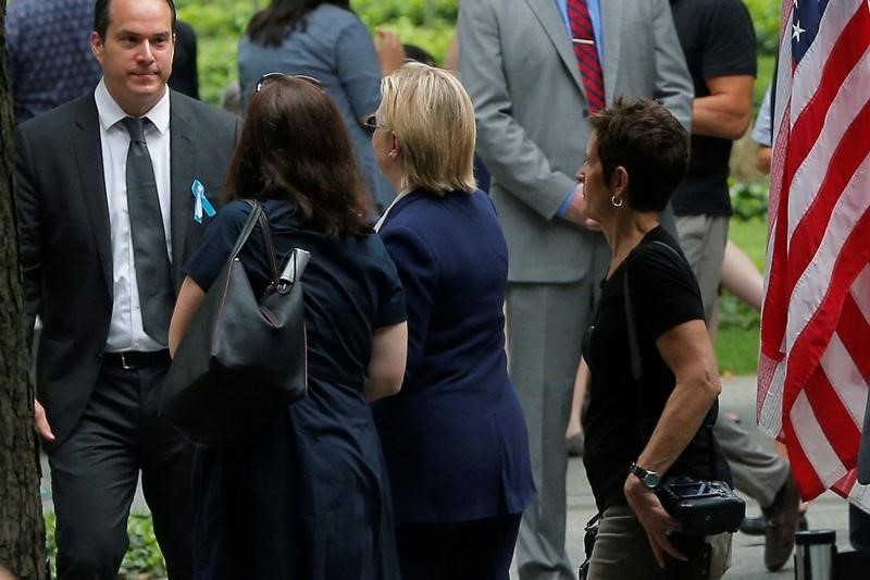 © Reuters. U.S. Democratic presidential candidate Hillary Clinton leaves ceremonies marking the 15th anniversary of the September 11 attacks at the National 9/11 Memorial in New York