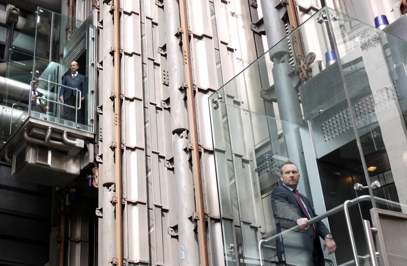 © Reuters. Men ride elevators at the headquarters of Lloyd's of London