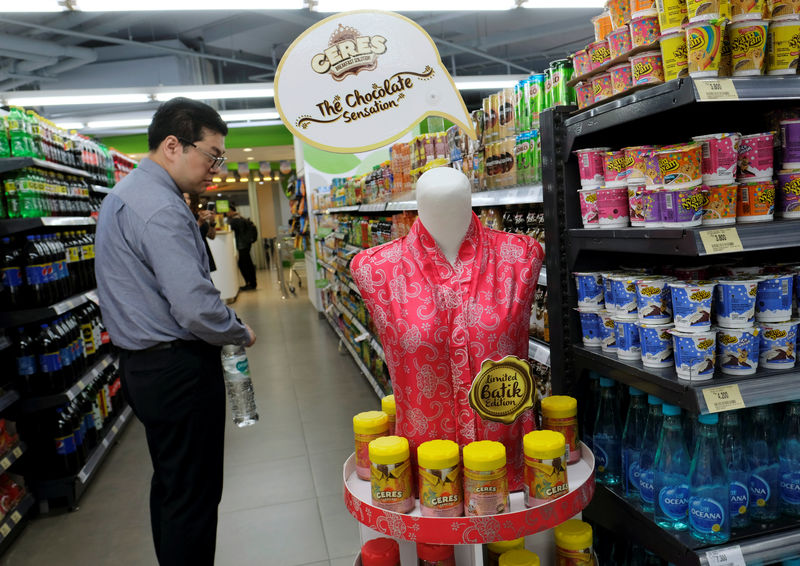 © Reuters. A man stands near Ceres chocolate products on promotion at Foodmart Fresh supermarket in Jakarta
