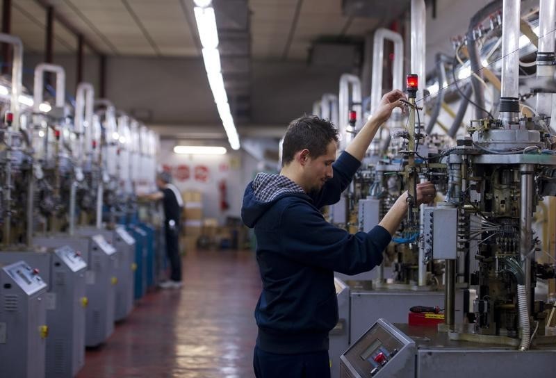 © Reuters. An employee works in a stocking factory in Calvisano near Brescia