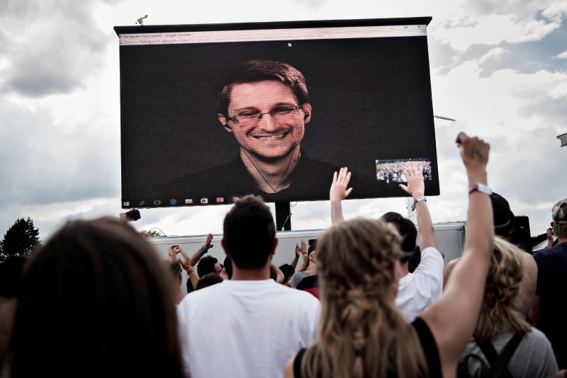 © Reuters. American whistleblower Edward Snowden is seen on a screen as he delivers a speech during the Roskilde Festival in Roskilde