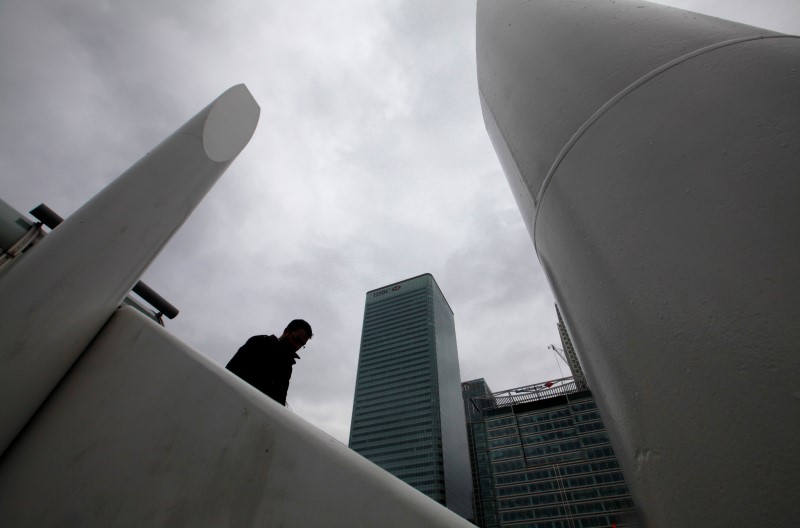 © Reuters. A man stands near the Canary Wharf business district, in east London