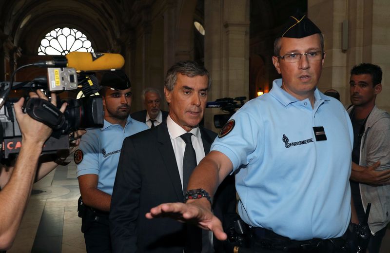 © Reuters. Former French budget minister Cahuzac, who resigned in 2013 after he admitted to have a Swiss bank account, arrives at the courtroom on the first day of his trial for tax fraud in Paris