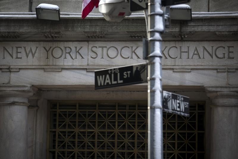 © Reuters. The Wall St. sign is seen outside the door to the New York Stock Exchange in New York's financial district