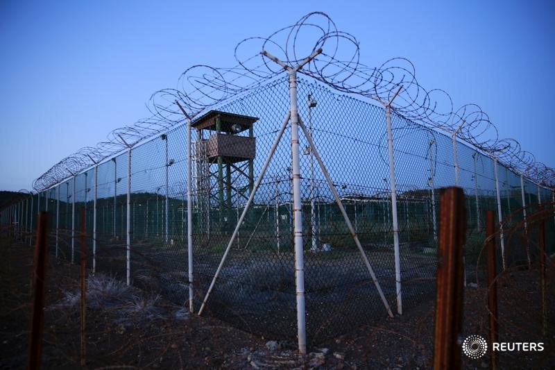 © Reuters. Chain link fence and concertina wire surrounds a deserted guard tower within Joint Task Force Guantanamo's Camp Delta