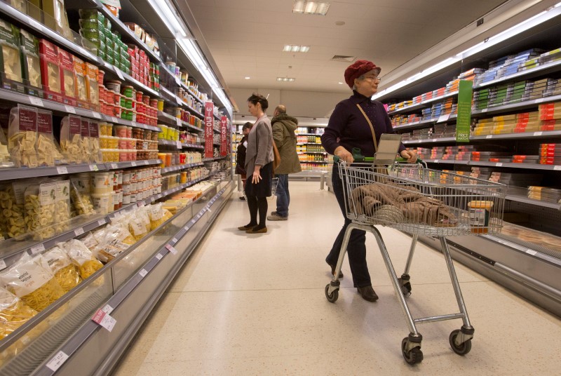 © Reuters. Shoppers browse the aisles in the Canary Wharf store of Waitrose in London