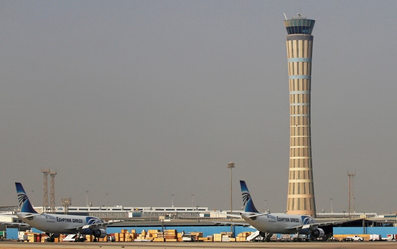 © Reuters. EgyptAir planes are parked in front of the air traffic control tower at Cairo Airport