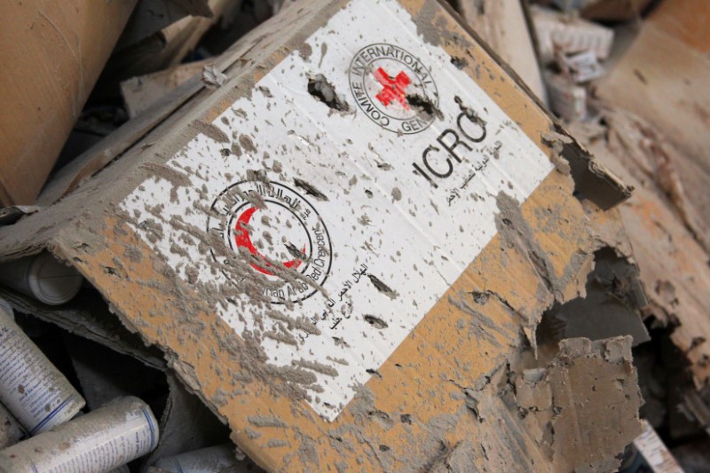 © Reuters. Damaged Red Cross and Red Crescent medical supplies lie inside a warehouse after an airstrike on the rebel held Urm al-Kubra town