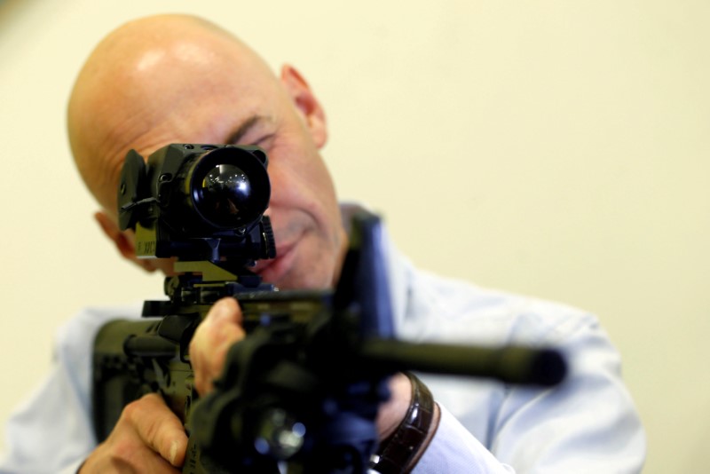 © Reuters. An employee looks through an infrared scope placed on a weapon during a demonstration at a preview presentation at Elbit Systems, Israel's biggest publicly listed defense firm, in Netanya, Israel