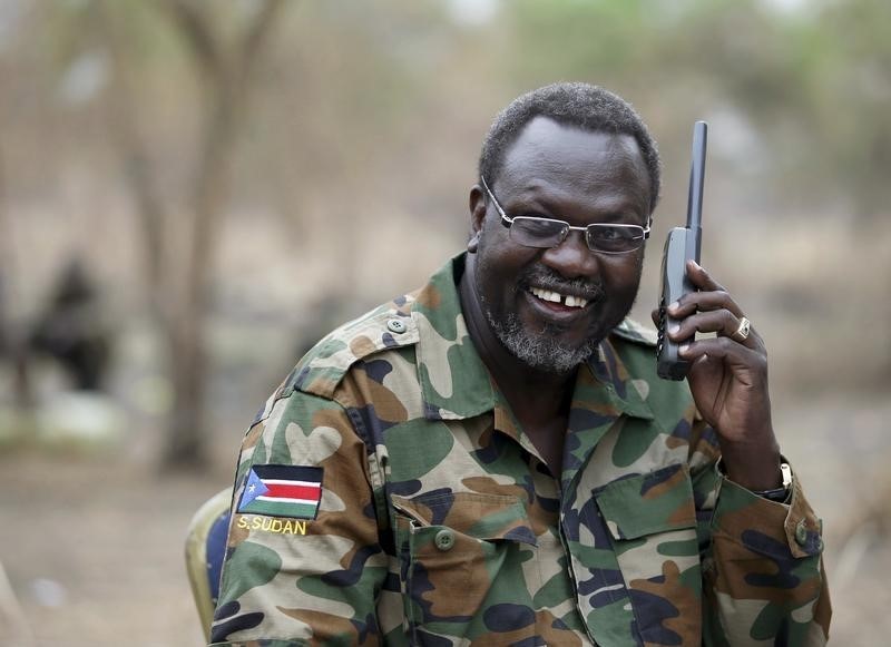 © Reuters. A file photo shows South Sudan's rebel leader Riek Machar talking on the phone in his field office in a rebel-controlled territory in Jonglei State