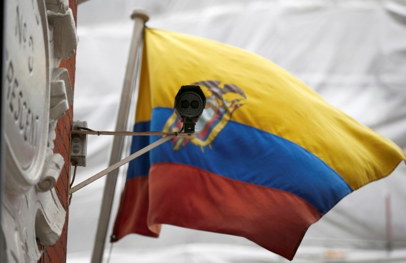 © Reuters. A national flag flies behind a security camera outside the Ecuadorian Embassy where WikiLeaks founder Julian Assange is taking refuge, in London