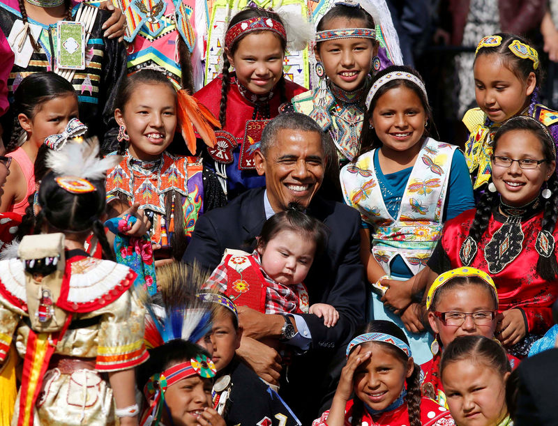 © Reuters. U.S. President Obama holds a baby as he poses with children at Cannon Ball Flag Day Celebration in Standing Rock Sioux Reservation in North Dakota