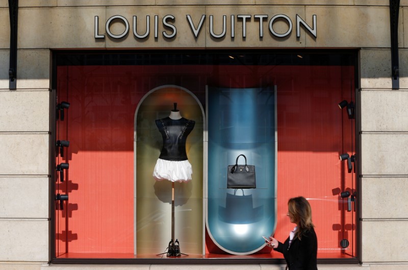 © Reuters. A woman walks past a Louis Vuitton shop in Brussels
