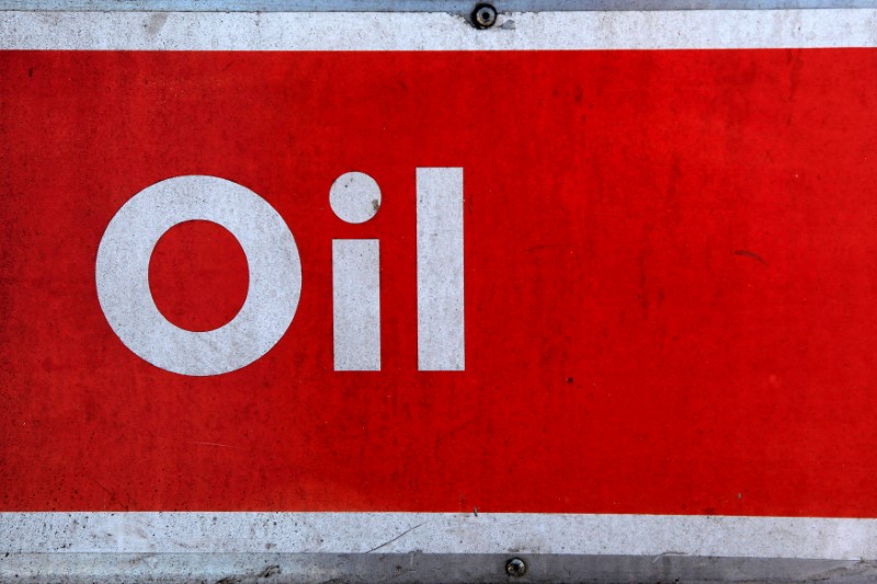 © Reuters. The word oil is pictured on an oil bank at a recycling yard in London