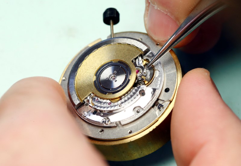 © Reuters. A watchmaker works on a mechanical watch movement in the Dubois Depraz workshop in Le Lieu