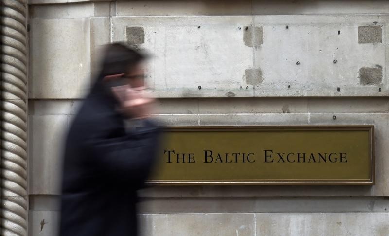 © Reuters. A worker walks past The Baltic Exchange in London