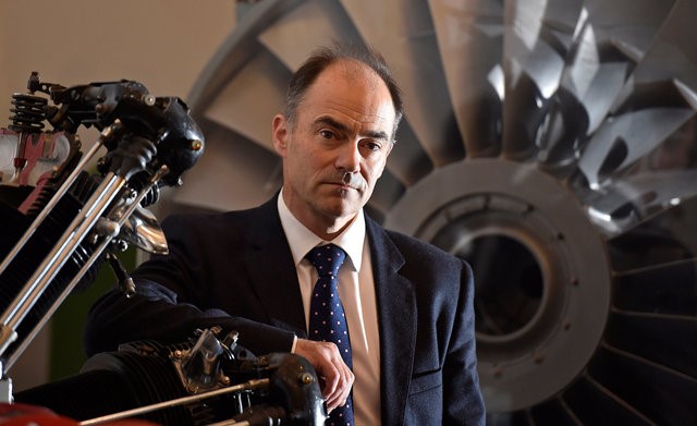 © Reuters. Warren East, CEO of Rolls-Royce, poses for a portrait in front of a Pegasus airplane engine at the company's aerospace engineering and development site in Bristol