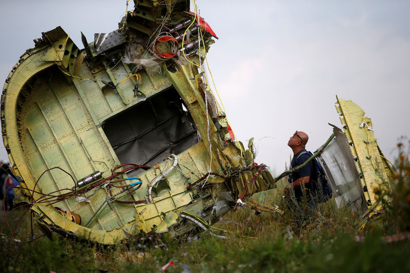 © Reuters. Malaysian air crash investigator inspects crash site of Malaysia Airlines Flight MH17 near Hrabove