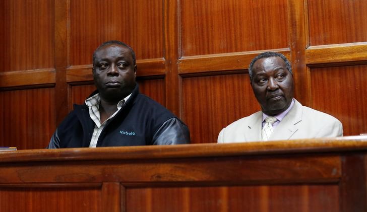 © Reuters. National Olympic Committee of Kenya (NOC-K) secretary general Paul and vice-chairman Ochieng sit inside the dock at the Milimani Law court in Kenya's capital Nairobi