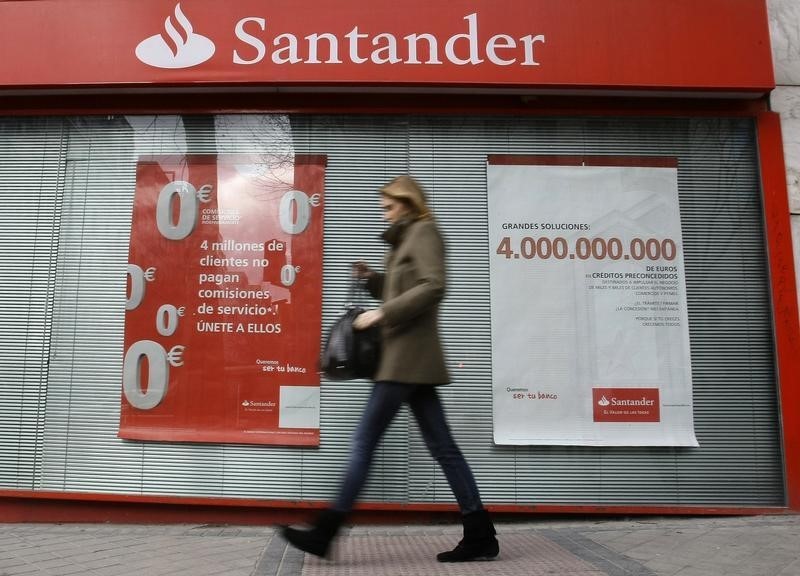 © Reuters. A woman walks past a Santander bank branch in Madrid