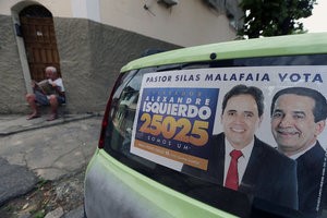 © Reuters. An election banner that reads "Pastor Silas Malafaia votes, councilman Alexandre Isquierdo, 25025, we are one" is pictured in Rio de Janeiro