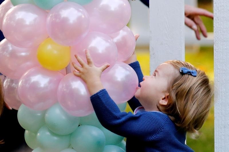 © Reuters. Britain's Princess Charlotte plays with baloons at a children's party at Government House in Victoria