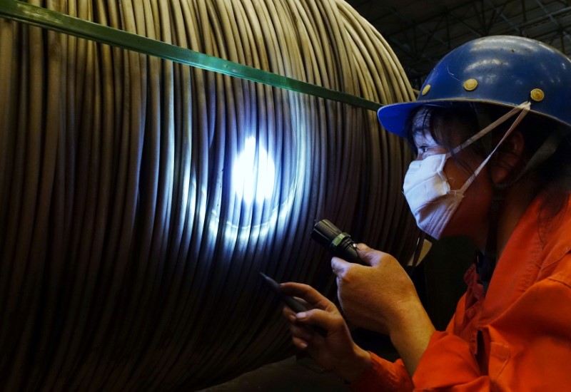 © Reuters. A worker check on product at a steel factory in Dalian