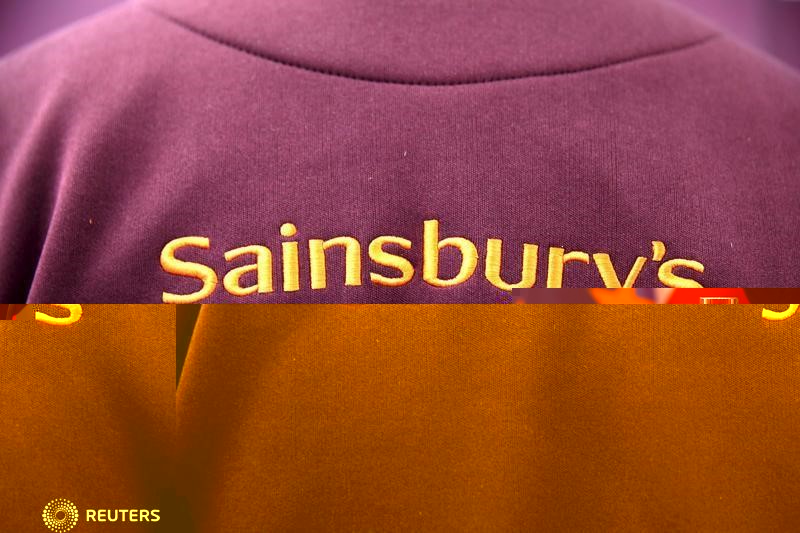 © Reuters. The Sainsbury's Logo is displayed on an employee uniform in a store in London, Britain