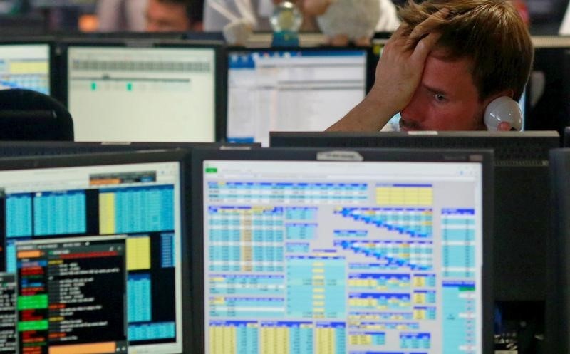 © Reuters. Traders from BGC, a global brokerage company in London's Canary Wharf financial centre react as European stock markets open