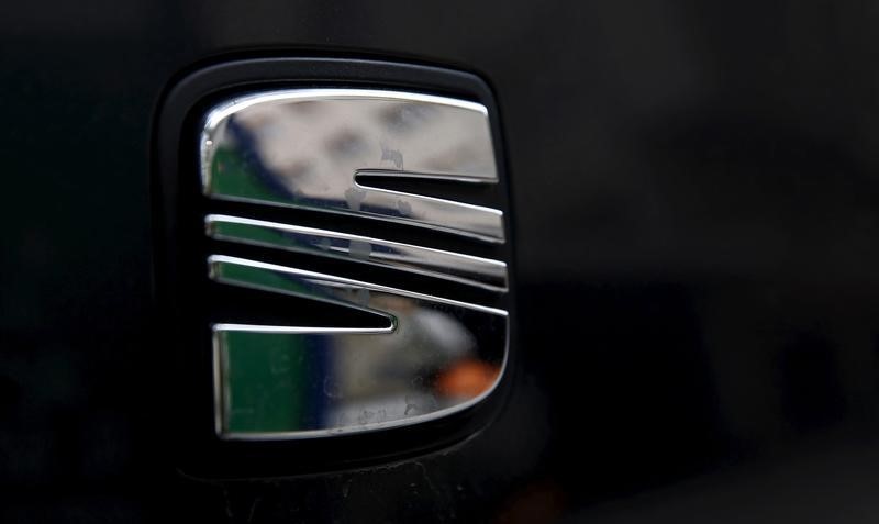 © Reuters. A woman is reflected on the logo of Spanish automaker SEAT in Barcelona