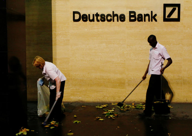 © Reuters. Workers sweep leaves outside Deutsche Bank offices in London