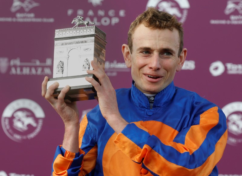 © Reuters. Irish Ryan-Lee Moore on Found celebrates with his trophy after he won the Qatar Prix de l'Arc de Triomphe at the Chantilly racetrack near Paris
