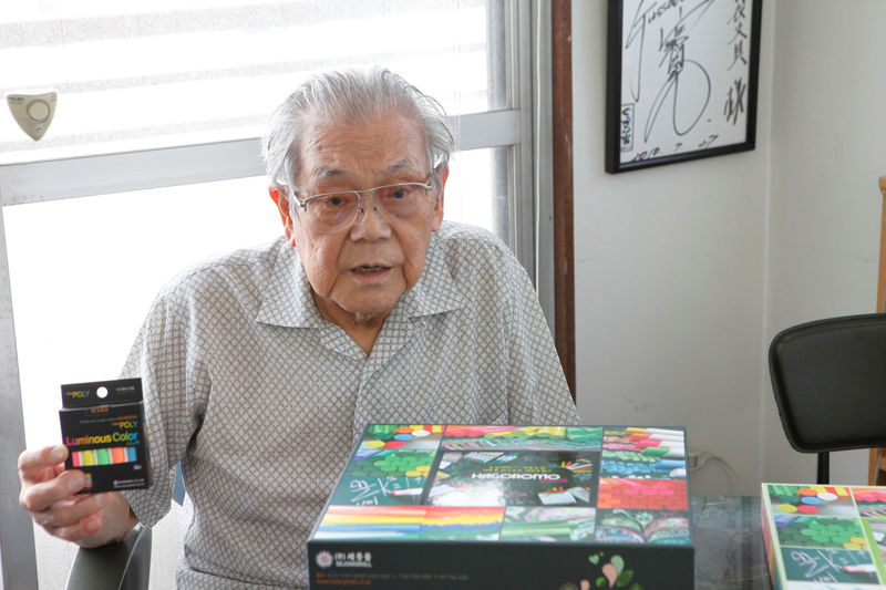 © Reuters. Takayasu Watanabe holds a box of chalks at his office where he used to run chalk-making business for decades before closing down last year, during an interview with Reuters in Nagoya