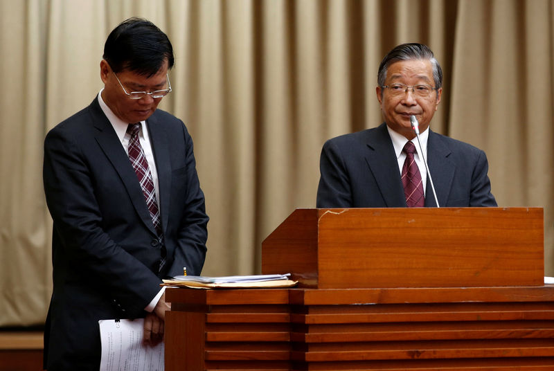 © Reuters. Financial Supervisory Commission (FSC) chairman Ding Kung-Wha (L) and Mega Financial's chairman Michael Chang attend a parliamentary session at Legislative Yuan in Taipei