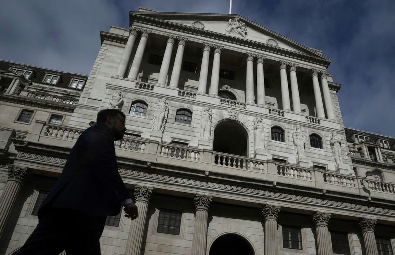 © Reuters. A man walks past the Bank of England in the City of London